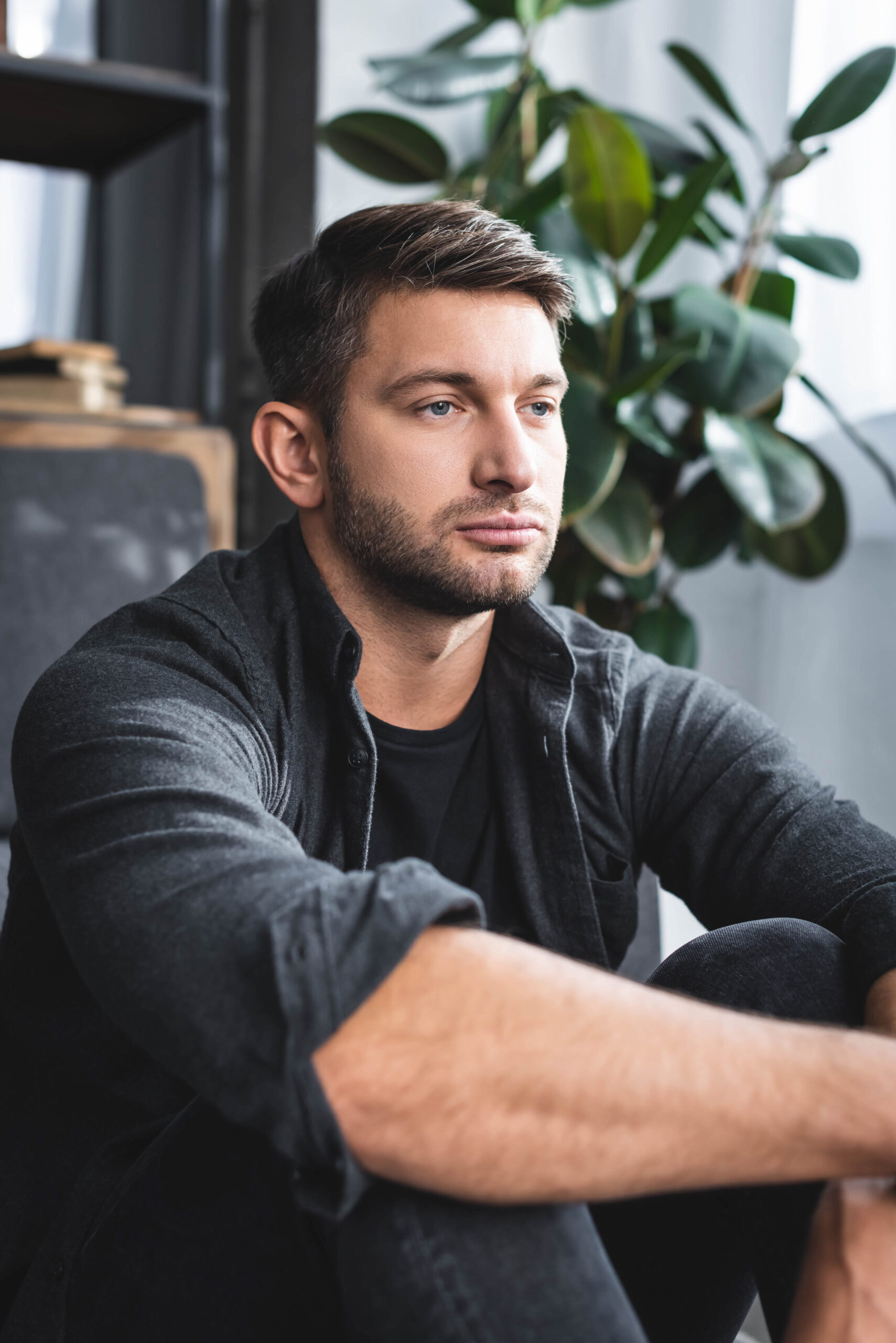 handsome man in black t-shirt looking away